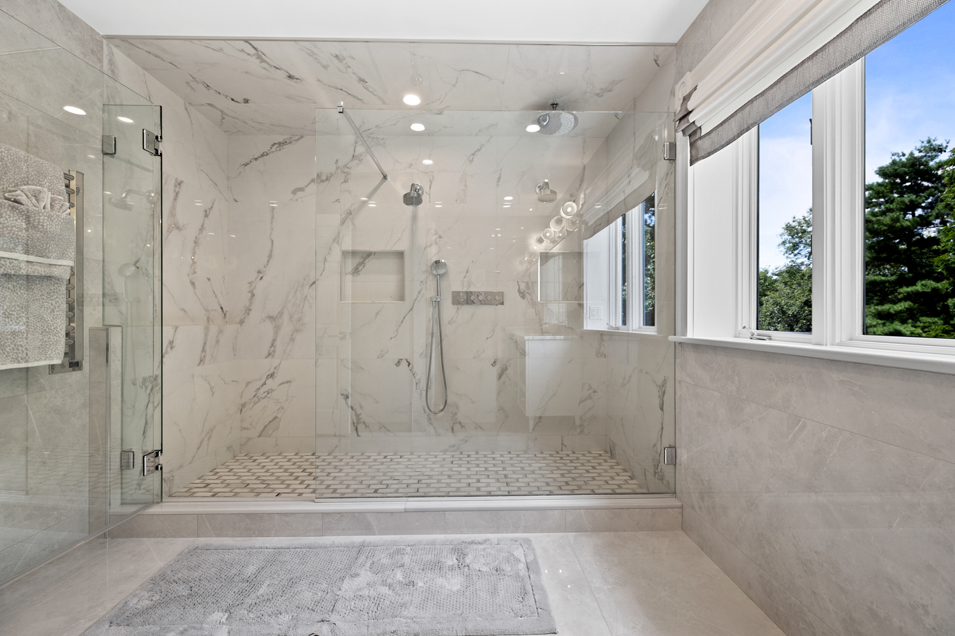 Luxurious marble bathroom with custom vanity and lighting